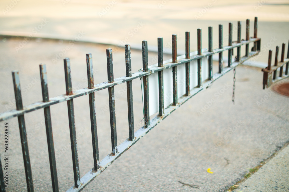 Metal fence symbolizes boundaries, security, protection, privacy, and delineates spaces with its strong and sturdy presence