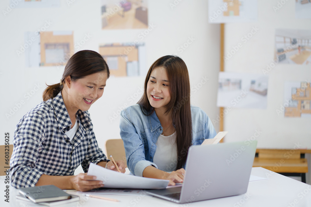 Confident working woman Asian Architects designer construction plans on blueprint. Confident working woman Asian Architects designer construction plans on blueprint.