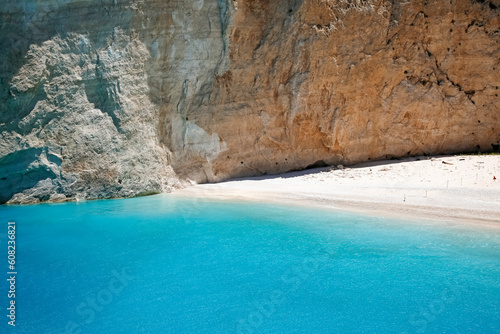 part of Navagio beach with high cliff and turquoise water, touristic famous landmark on Zakynthos island, Greece