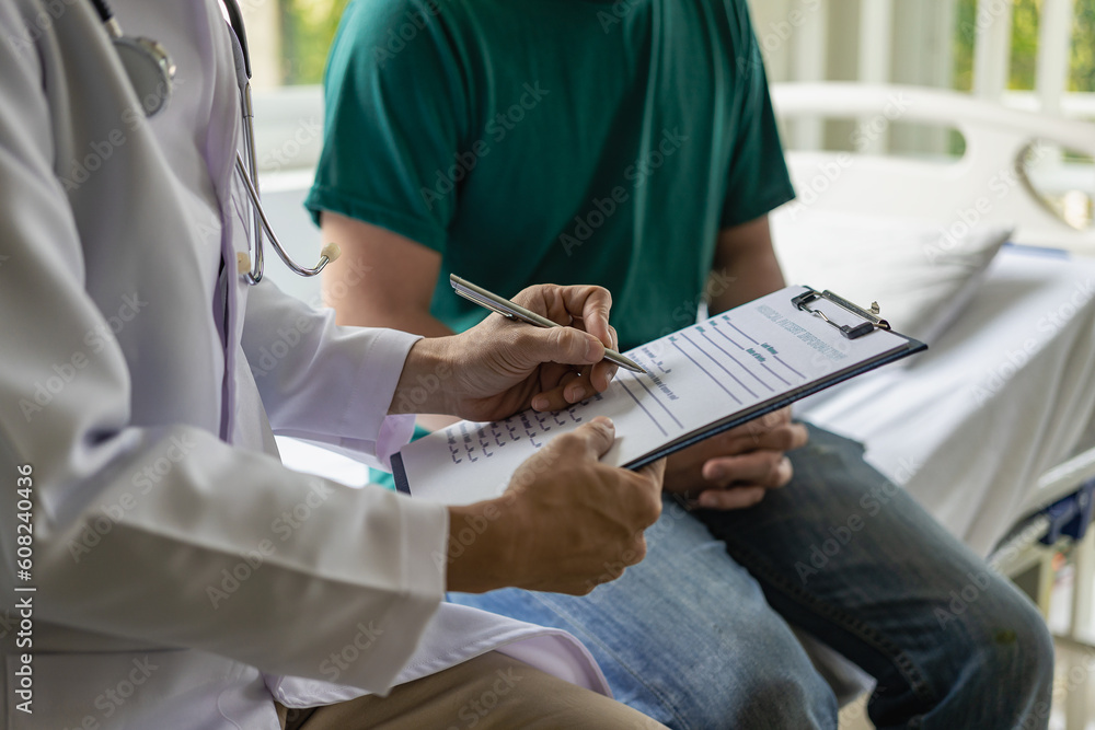 Male patients talk to doctors at modern clinics or hospitals. A male doctor in a white coat advises and advises a young man who is sitting at a table. Male patients talk to doctors at modern clinics or hospitals. A male doctor in a white coat advises and advises a young man who is sitting at a table.