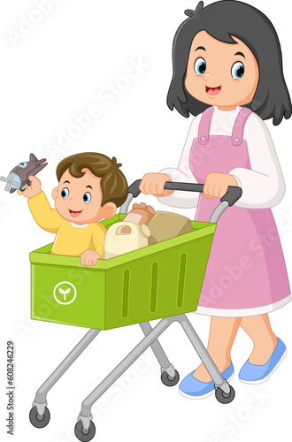 a mother is happily shopping at the supermarket with her son with a shopping cart