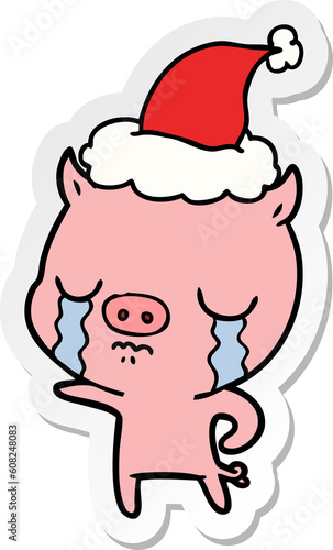 hand drawn sticker cartoon of a pig crying wearing santa hat
