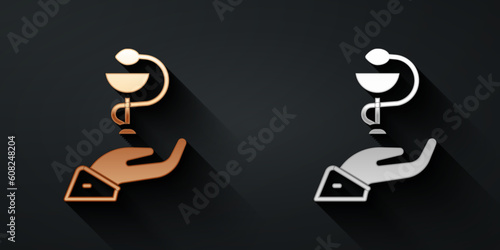 Gold and silver Caduceus snake medical symbol icon isolated on black background. Medicine and health care. Emblem for drugstore or medicine, pharmacy. Long shadow style. Vector