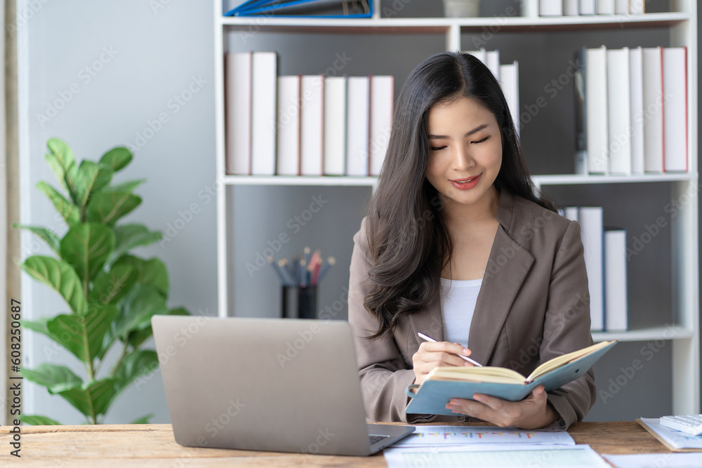 Businesswoman using laptop for doing financial mathematics on wooden table in business office, statistics and analytical research concept, accounting, tax Businesswoman using laptop for doing financial mathematics on wooden table in business office, statistics and analytical research concept, accounting, tax