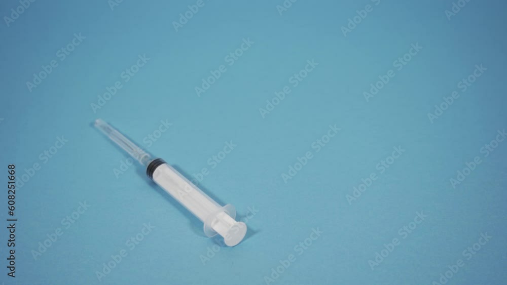 White syringe falls on the blue floor White syringe falls on the blue floor