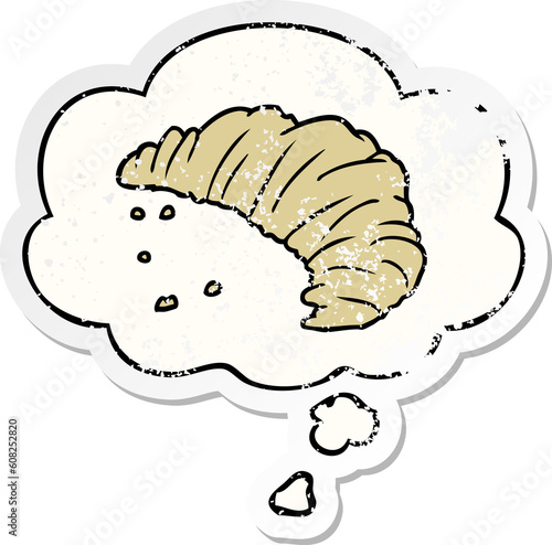 cartoon croissant with thought bubble as a distressed worn sticker