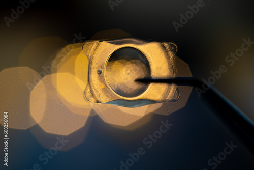 photo of Implantable Collamer Lens ICL for treating refractive errors, infront of lights photo