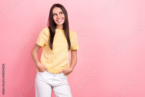 Photo of pretty lady professional look side empty space wondered wear yellow shirt white jeans pants isolated pink color background