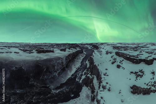 Amazing landscape with polar lights over frozen terrain