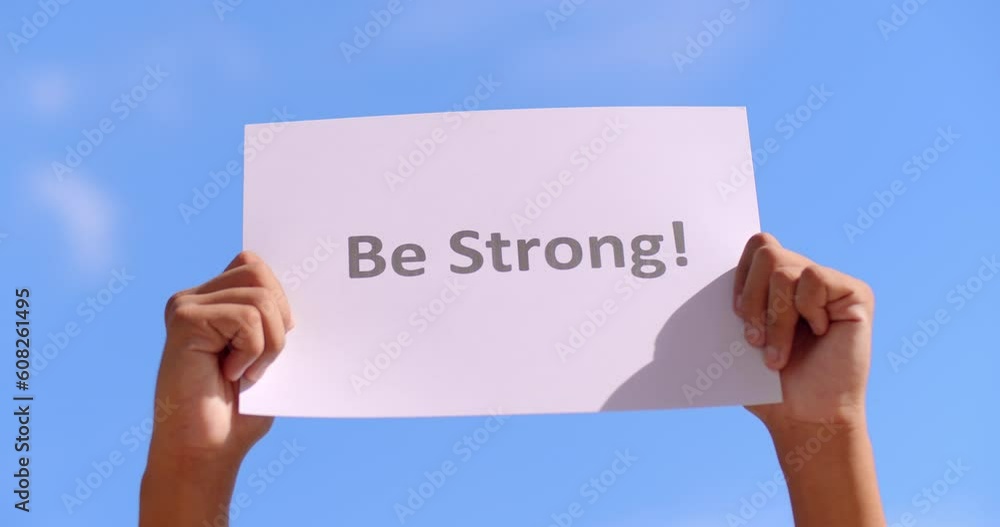 A person raise a paper sign saying A person raise a paper sign saying