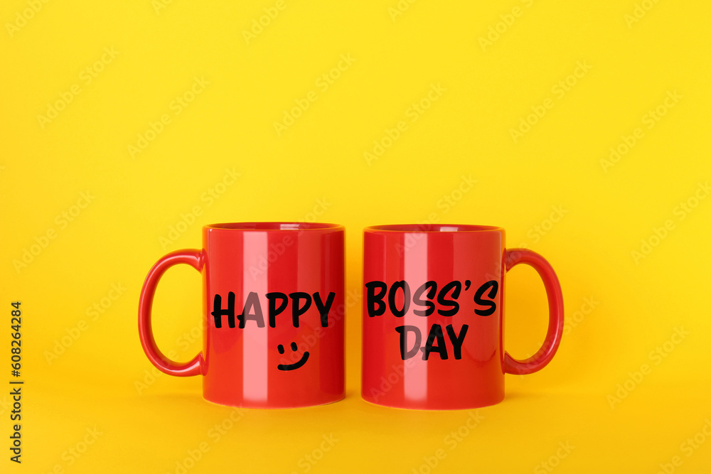 Happy Boss`s Day. Greeting card design with red mugs on yellow background Happy Boss`s Day. Greeting card design with red mugs on yellow background