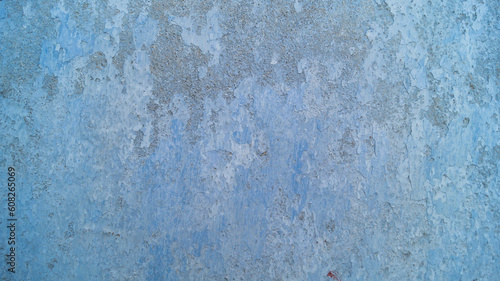 Blue wall of the house. The old wall of the house is painted blue. The old wall of the house is cracked. Background crack in the wall of the house