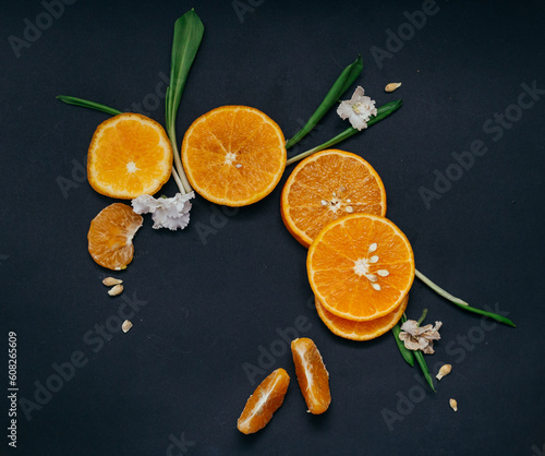 mandarin orange cut into slices close-up on a dark background photo