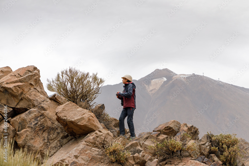 Teenage girl exploring among the volcanic rocks of the Teide volcano