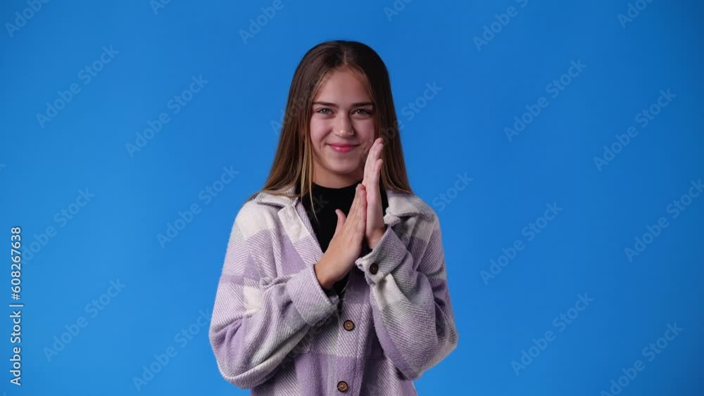 4k video of girl with cunning facial expression on blue background. 4k video of girl with cunning facial expression on blue background.