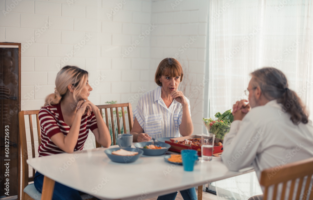 Members of the family from multiple generations enjoy quality time together by eating, snacking, chatting, discussing, learning about each other's interests, and strengthening stronger relationships. Members of the family from multiple generations enjoy quality time together by eating, snacking, chatting, discussing, learning about each other's interests, and strengthening stronger relationships.