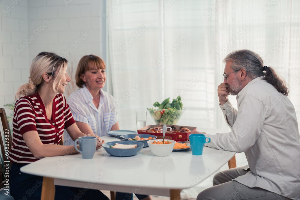 Members of the family from multiple generations enjoy quality time together by eating, snacking, chatting, discussing, learning about each other's interests, and strengthening stronger relationships. Members of the family from multiple generations enjoy quality time together by eating, snacking, chatting, discussing, learning about each other's interests, and strengthening stronger relationships.
