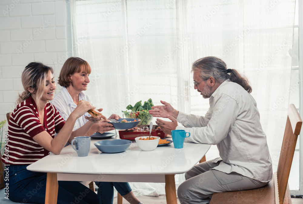Members of the family from multiple generations enjoy quality time together by eating, snacking, chatting, discussing, learning about each other's interests, and strengthening stronger relationships. Members of the family from multiple generations enjoy quality time together by eating, snacking, chatting, discussing, learning about each other's interests, and strengthening stronger relationships.
