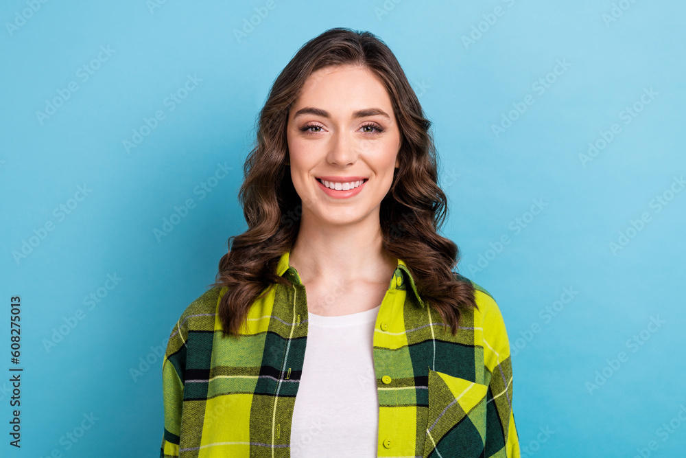 Portrait of friendly gorgeous pretty girl with wavy hairstyle wear plaid jacket toothy smiling at camera isolated on blue color background Portrait of friendly gorgeous pretty girl with wavy hairstyle wear plaid jacket toothy smiling at camera isolated on blue color background