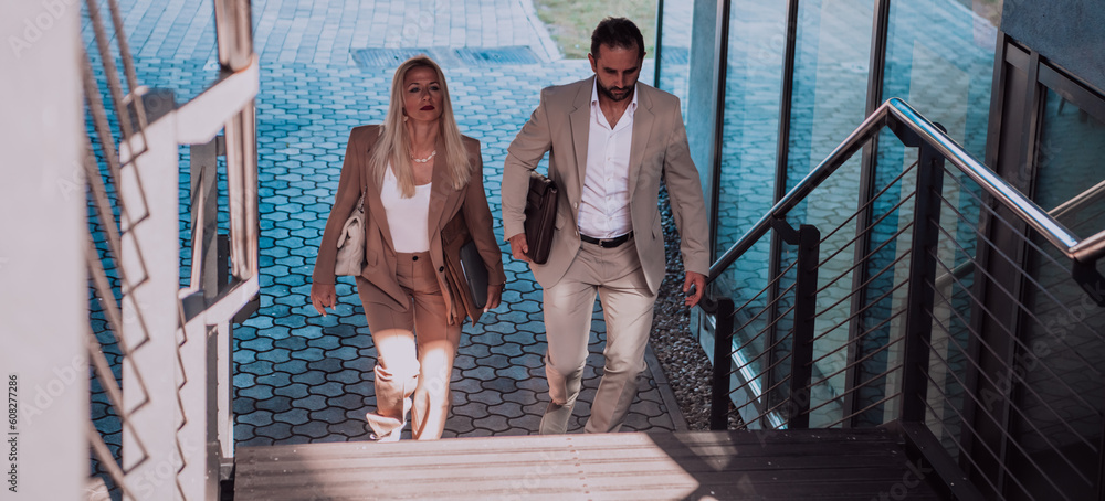 Fototapeta premium Modern business couple after a long day's work, walking together towards the comfort of their home, embodying the perfect blend of professional success and personal contentment.