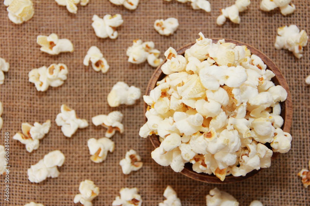 White fried popcorn on a brown background White fried popcorn on a brown background