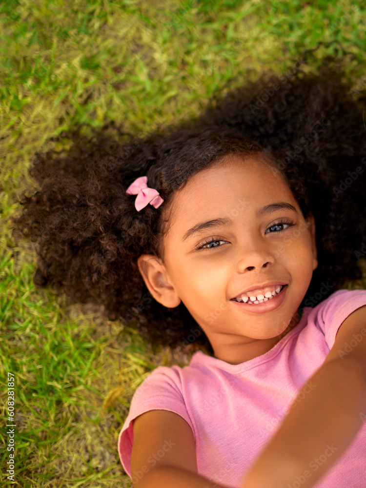 POV Overhead Shot Of Smiling Girl Lying On Grass Taking Selfie On Mobile Phone POV Overhead Shot Of Smiling Girl Lying On Grass Taking Selfie On Mobile Phone