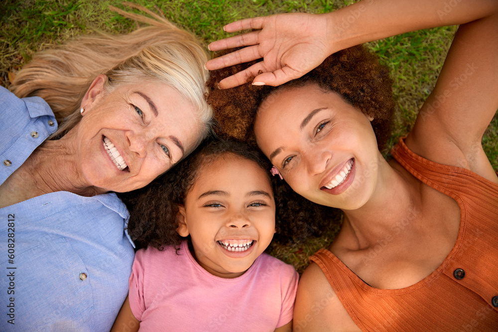 Overhead Portrait Shot Of Multi-Generation Female Family Lying On Grass Overhead Portrait Shot Of Multi-Generation Female Family Lying On Grass