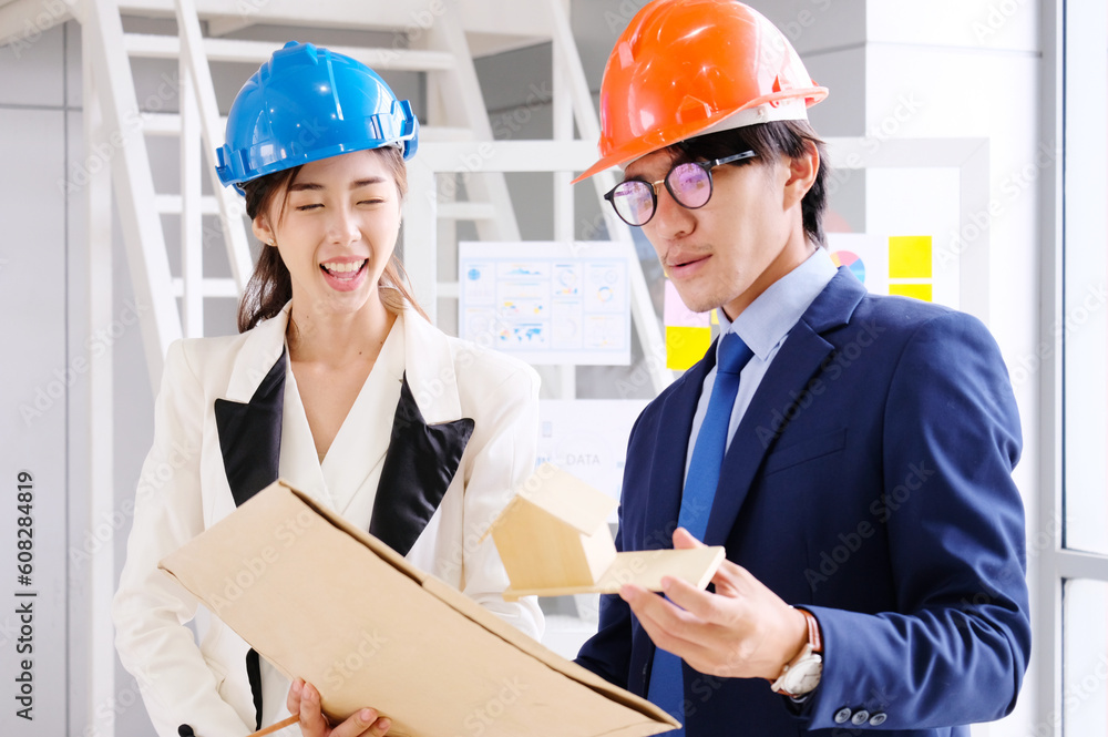 Engineers meeting to look at the drawings to design the structure of the house.