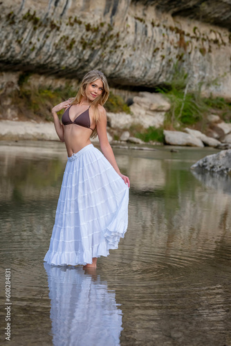 A Lovely Blonde Bikini Model Enjoys The Summer Weather On A Lake