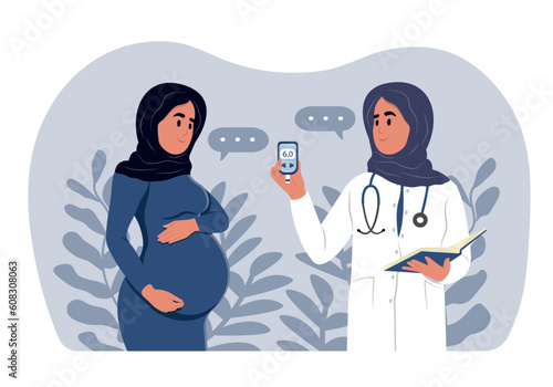 A young muslim smiling female doctor measures the sugar level of a pregnant muslim woman with a glucometer. Diabetes in pregnant women. World Diabetes Day. Gynecologist and obstetrician consultation.