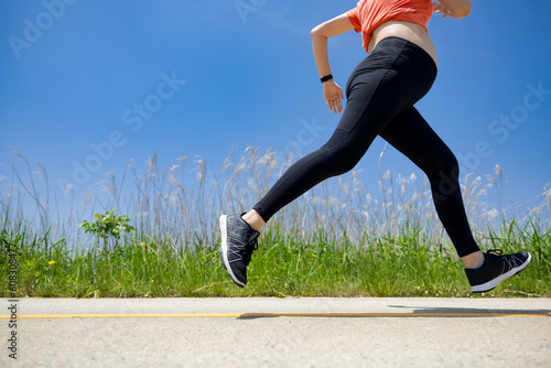 A pregnant woman is doing jogging exercise for health photo