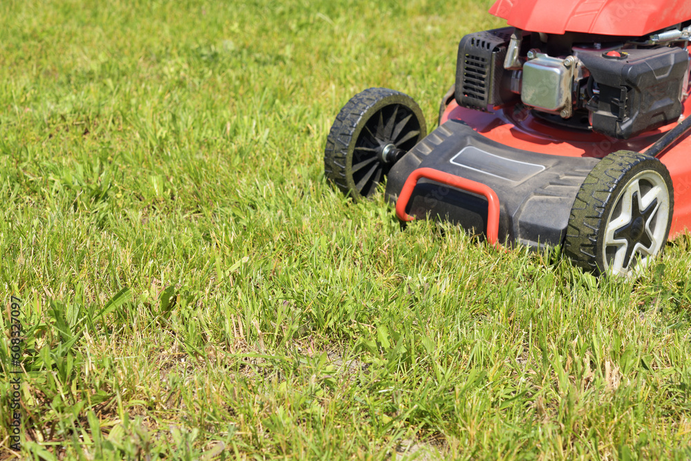 Lawn mower on cut grass. Mowing the grass. Lawn mower on cut grass. Mowing the grass.