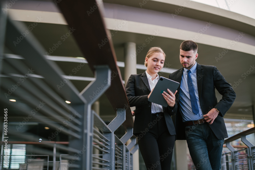 Two businesspeople looking at tablet outdoors. meeting plan. Communication concept. Two businesspeople looking at tablet outdoors. meeting plan. Communication concept.