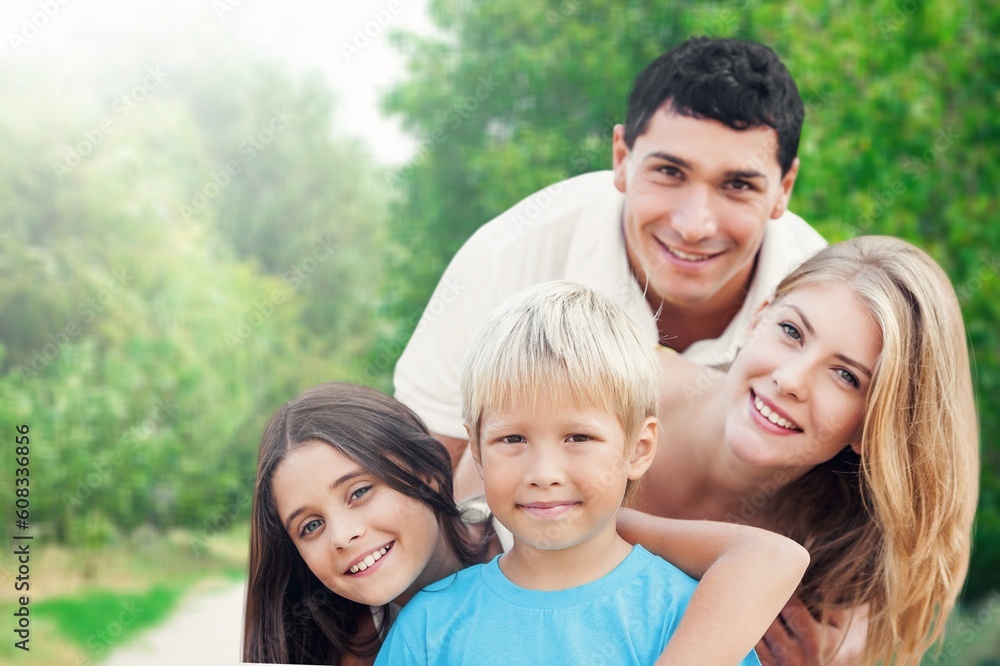Happy young family with children in nature park Happy young family with children in nature park