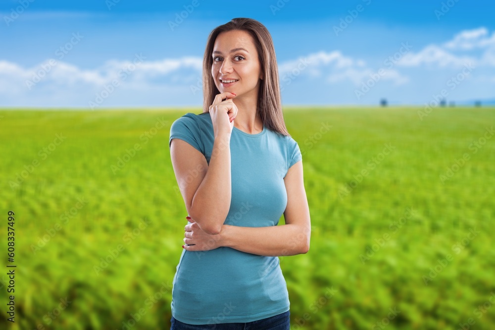Young woman on agriculture farming field in summer Young woman on agriculture farming field in summer