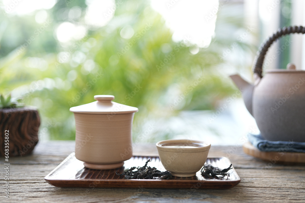 Tea cup and cactus pot and old tea pot on wooden table Tea cup and cactus pot and old tea pot on wooden table
