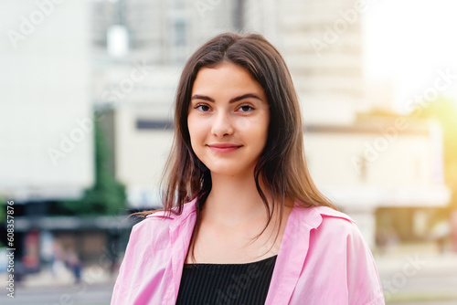 Street portrait of beautiful caucasian young woman with long hair. Authentic people outdoor photo concept. Free Download Street portrait of beautiful caucasian young woman with long hair. Authentic people outdoor photo concept. - GFXLoad