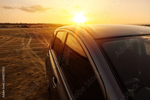 Beautiful sunset and modern Car Off-roading near the Beach