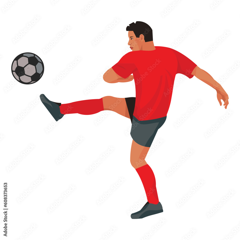 East asian footballer in red equipment in profile kicking the ball East asian footballer in red equipment in profile kicking the ball