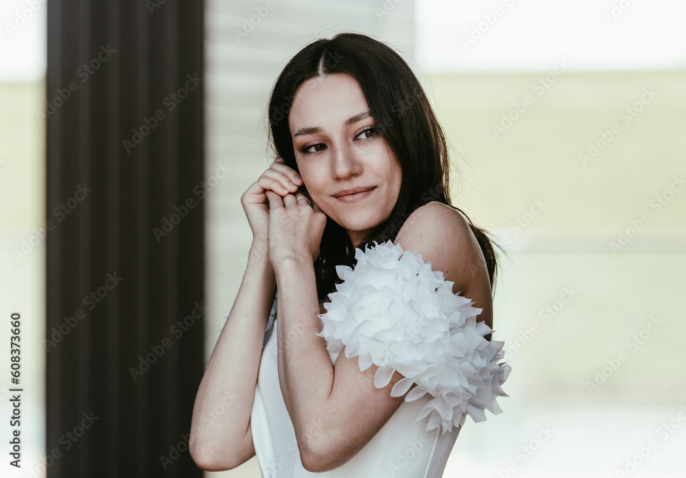 Portrait of a beautiful brunette in a white wedding dress Portrait of a beautiful brunette in a white wedding dress