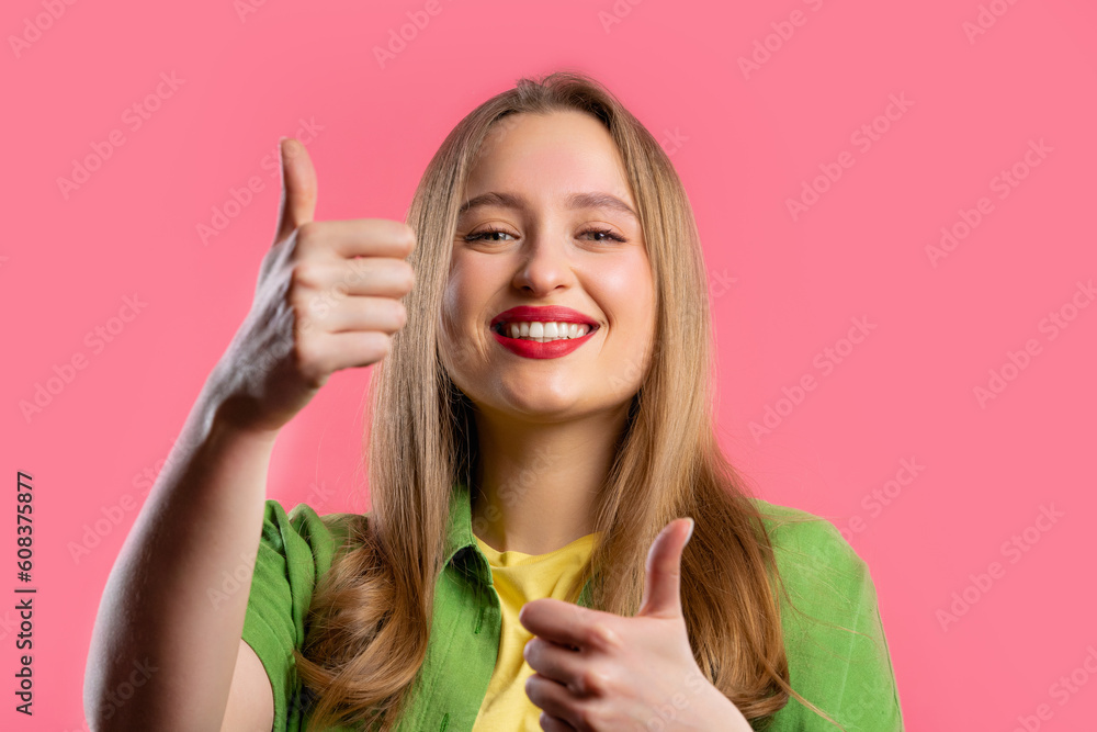 Stylish woman with hand sign like, thumbs up gesture. Lady on pink background Stylish woman with hand sign like, thumbs up gesture. Lady on pink background