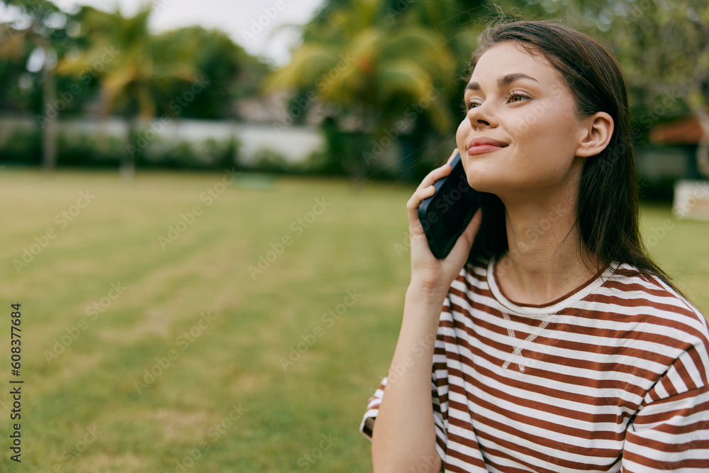 woman tree grass lifestyle blogger phone nature smiling happy female palm park woman tree grass lifestyle blogger phone nature smiling happy female palm park