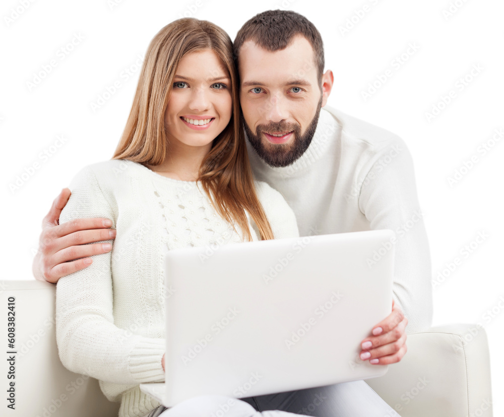 Portrait of a happy young couple using laptop on sofa