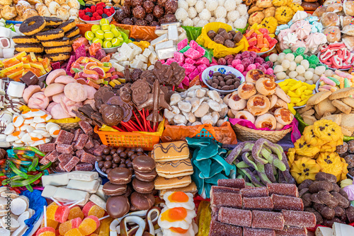 Traditional sweets: cookies, jelly, candy, chocolate, marshmallow, nuts and more at open market during catholic Corpus Christi celebration in Ecuador in Cuenca	