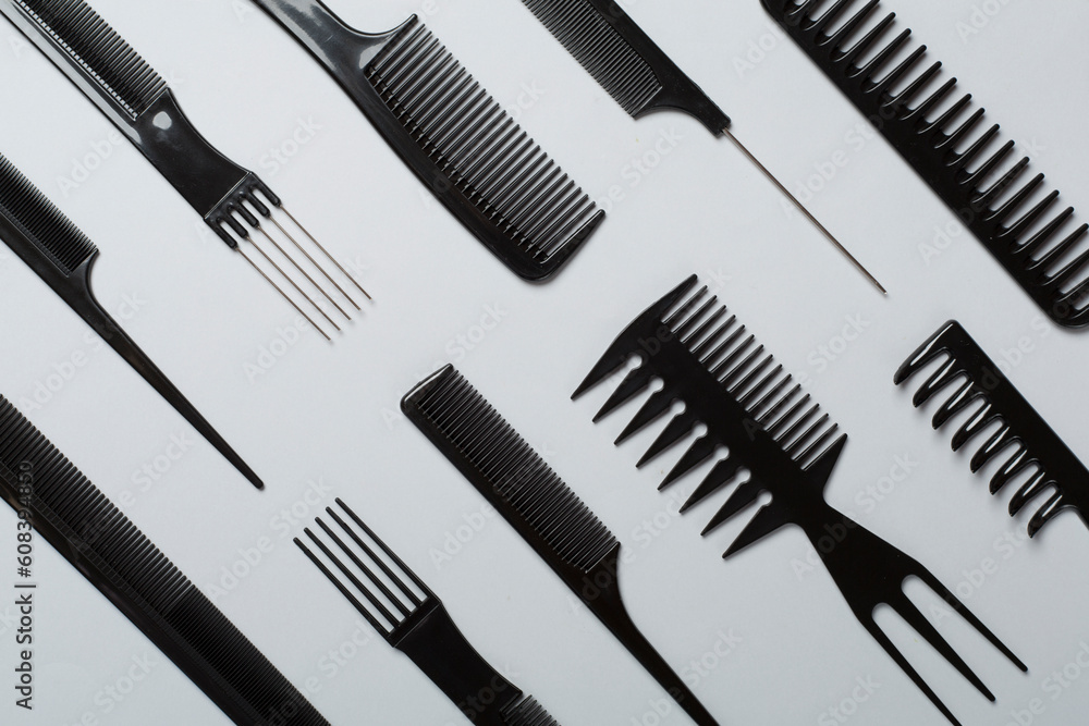 Professional combs and hairdresser tools on color background, top view Professional combs and hairdresser tools on color background, top view