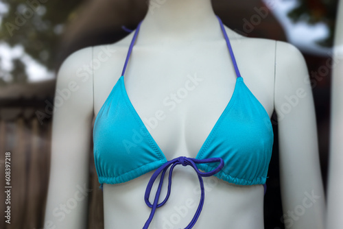 Closeup of blue bra of bikini on mannequin in a fashion store showroom