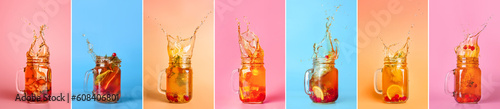 Foto Set of mason jars with splashing cold ice tea on color background