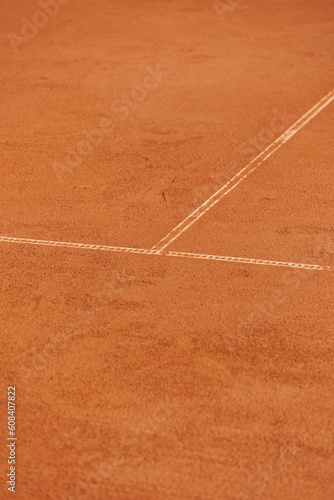 tennis court made of red clay soil with markings for game or competition. sports and recreation, professional performance champions in lawn tennis with rackets and balls. training of athletes outdoor