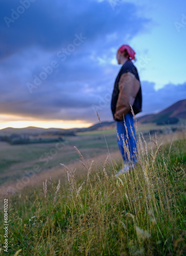 Girl On A Hillside At Sunset