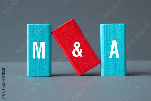 M and A - Mergers and Acquisitions, word concept on building blocks, text